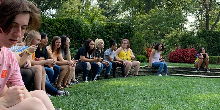 A group of students sitting outdoors
